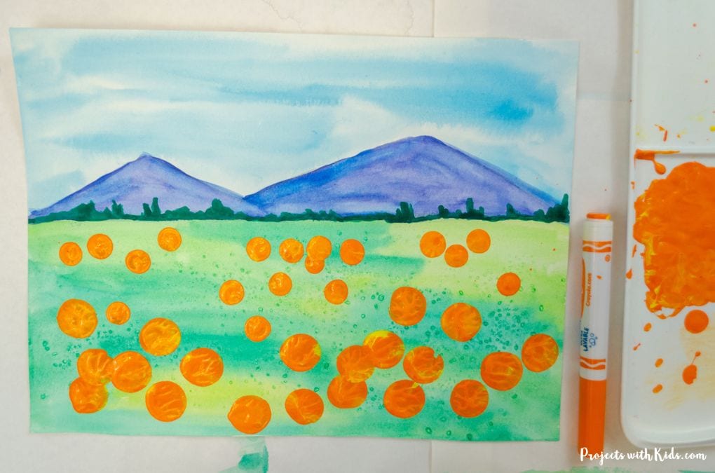 Colorful pumpkin patch art project using watercolor and acrylic techniques.