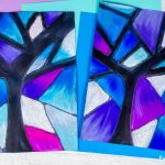 2 examples of a winter tree art project for kids using chalk pastels in shades of blue and purple on black paper using a glue resist technique.